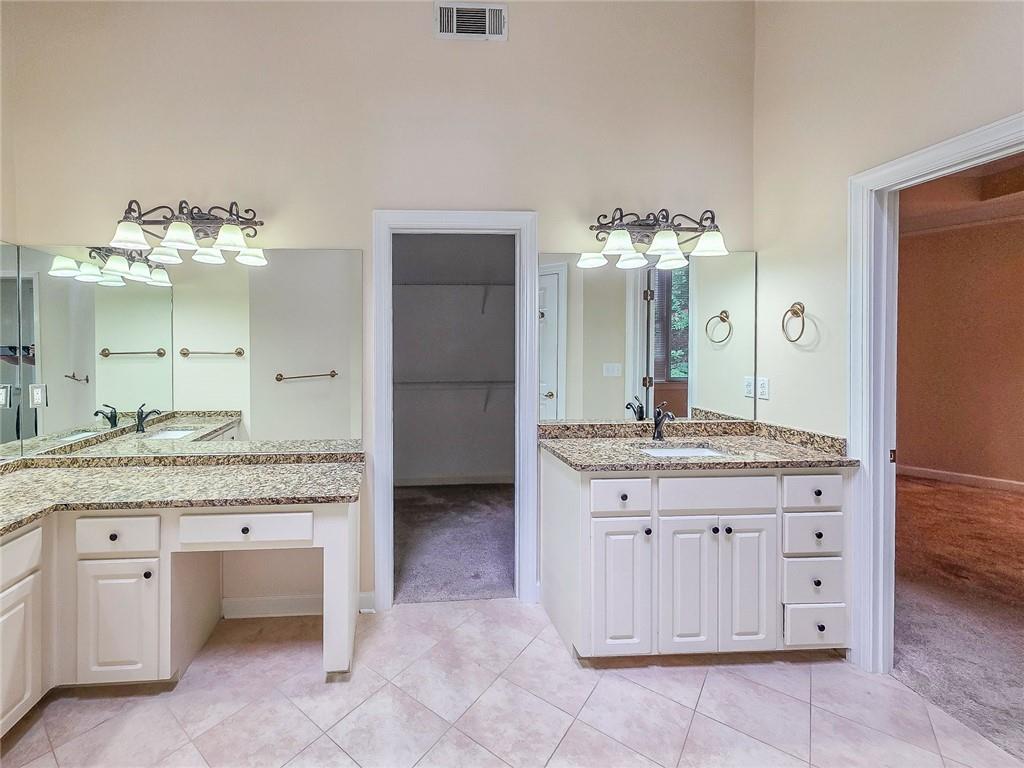 3712 Frederica Road Northwest Berkeley Lake, GA 30096 - Photo 28 of 49 a bathroom with a granite countertop sink a counter and a mirror