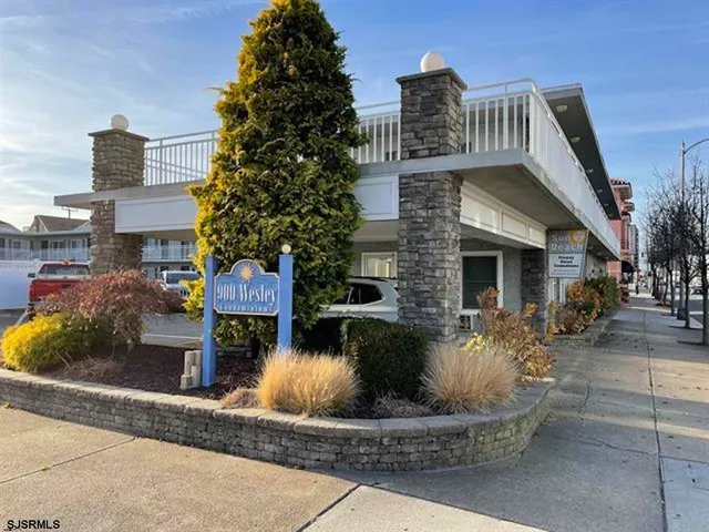 a front view of house with sign board and yard