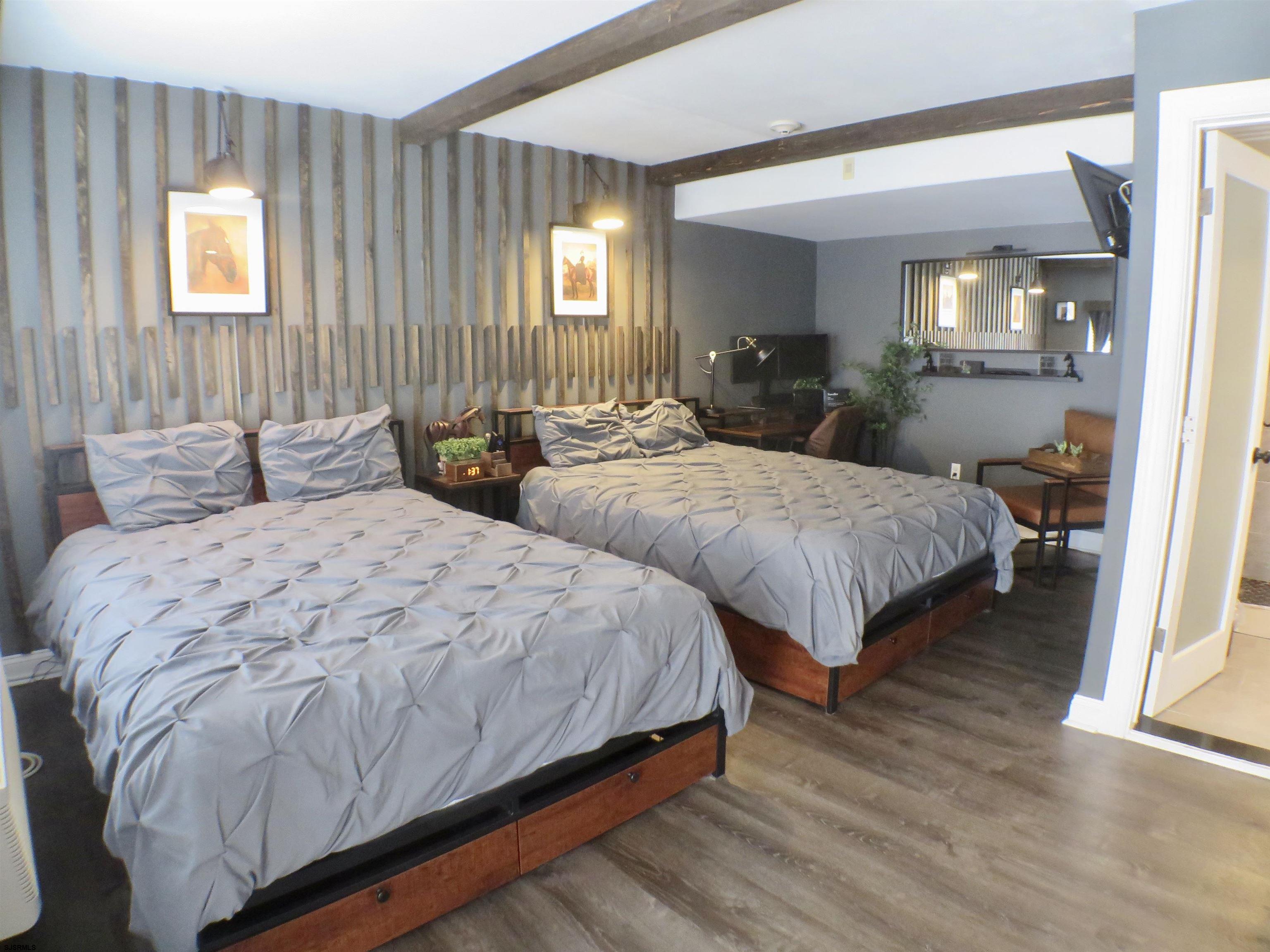 900 Wesley Avenue, Unit 103 Ocean City, NJ 08226 - Photo 11 of 15 a bedroom with two beds and painted walls