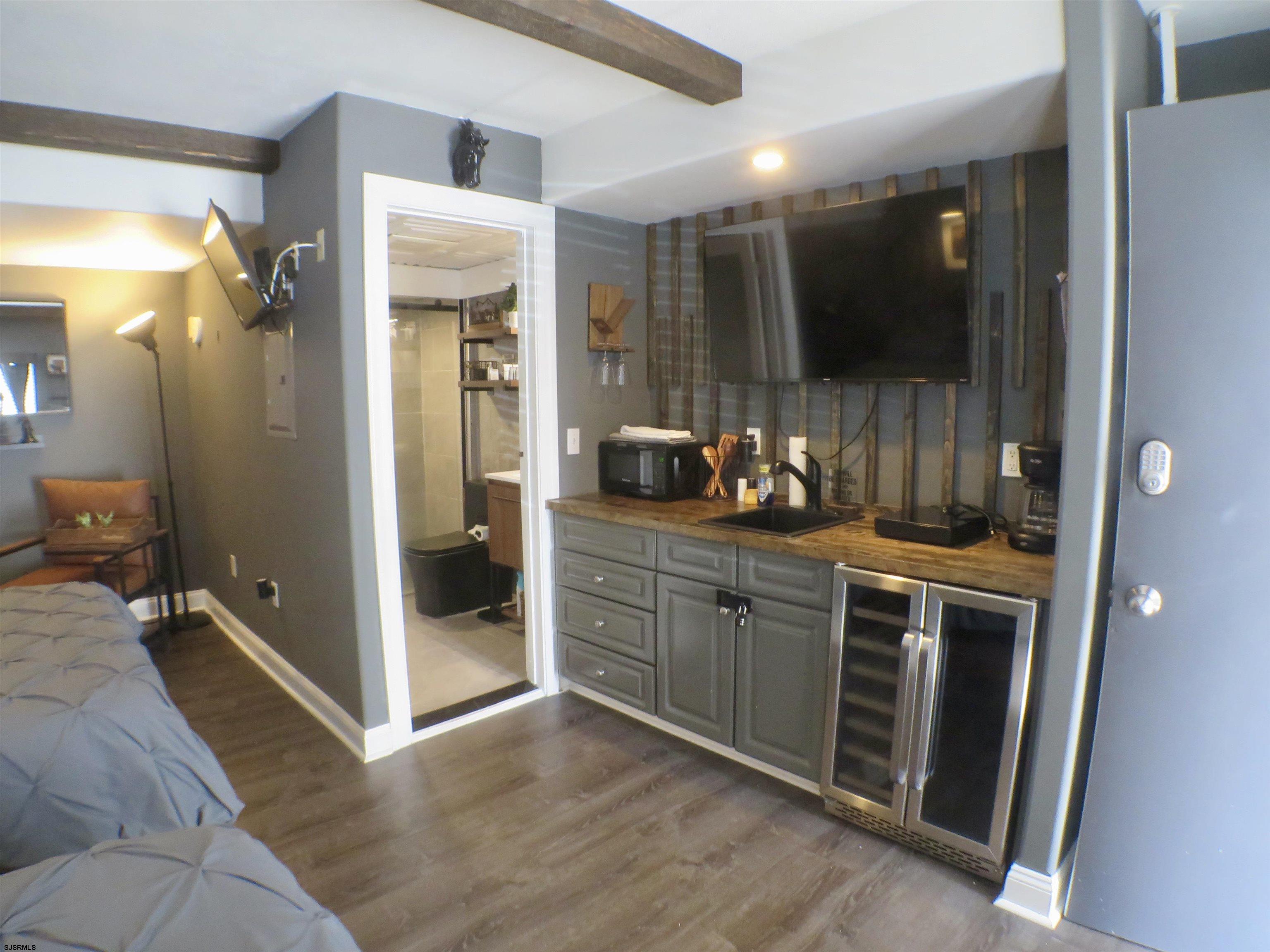 900 Wesley Avenue, Unit 103 Ocean City, NJ 08226 - Photo 5 of 15 a spacious bathroom with a double vanity sink and a mirror