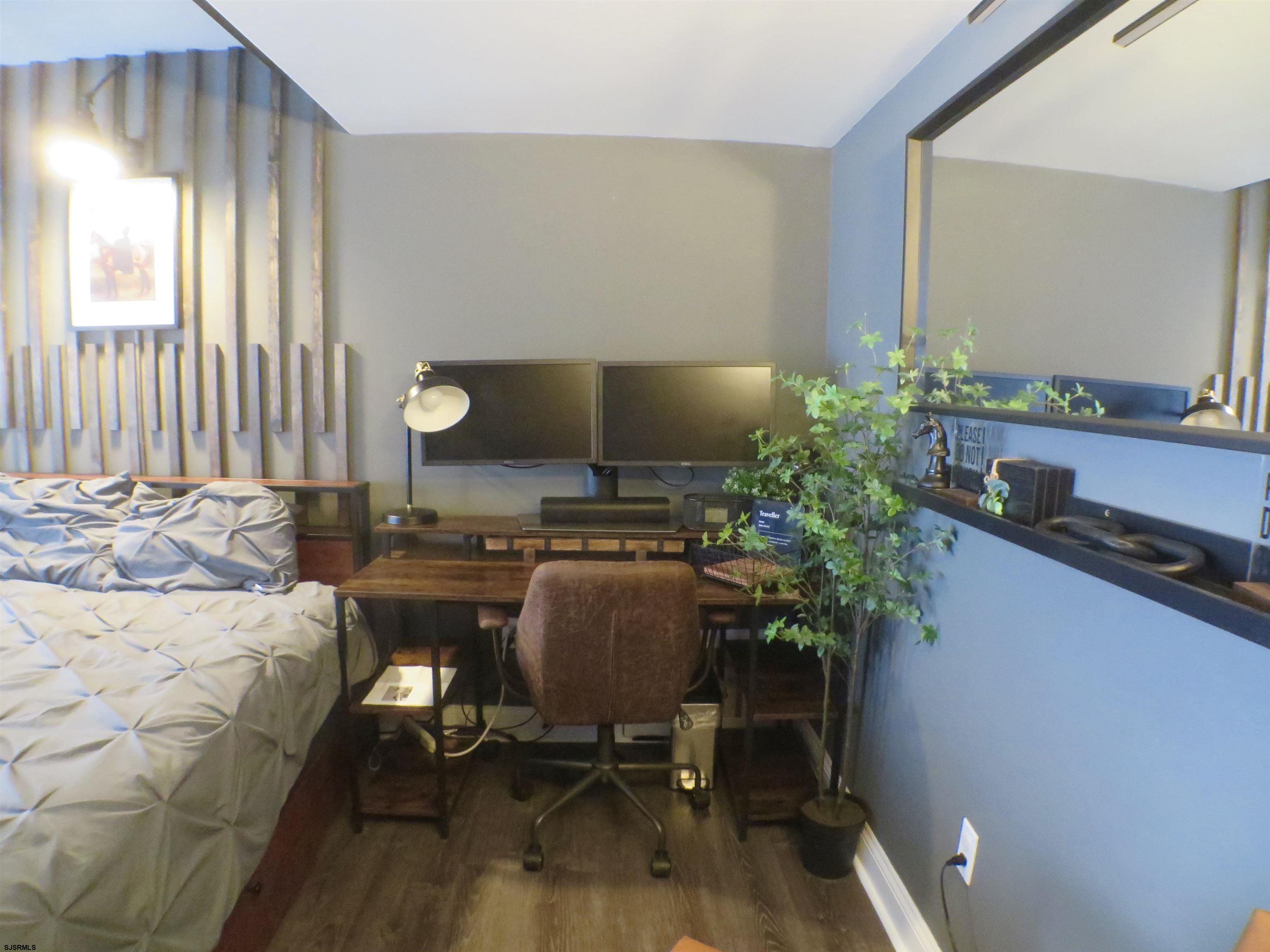 900 Wesley Avenue, Unit 103 Ocean City, NJ 08226 - Photo 7 of 15 a workspace with furniture and a potted plant