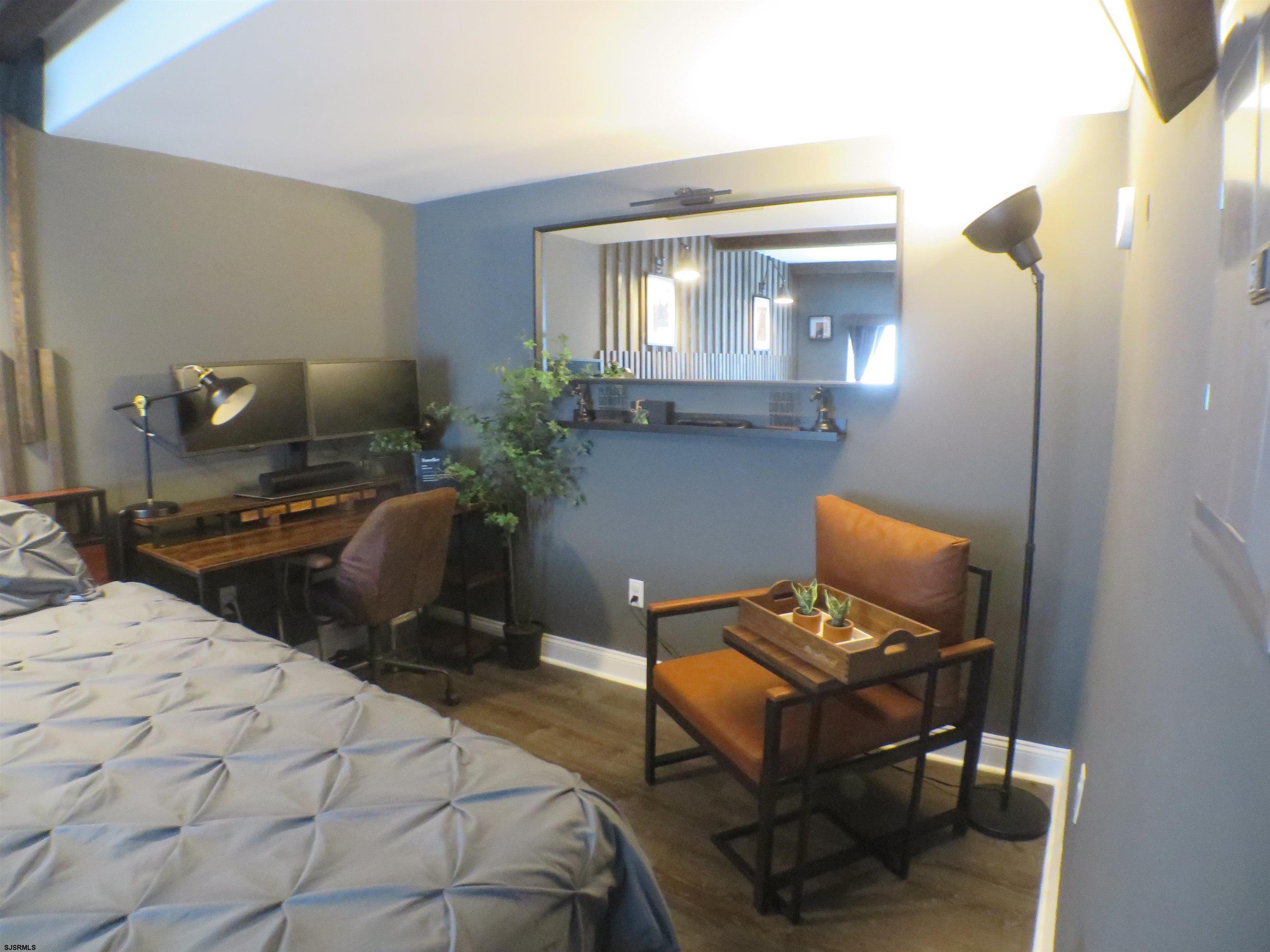 900 Wesley Avenue, Unit 103 Ocean City, NJ 08226 - Photo 8 of 15 a bedroom with furniture and a window