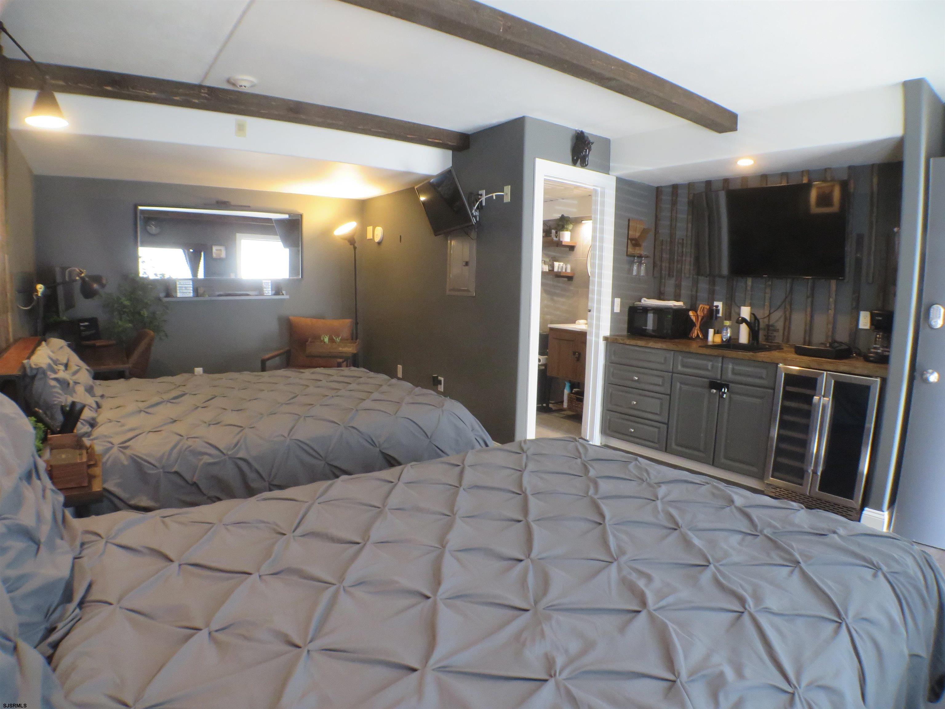 900 Wesley Avenue, Unit 103 Ocean City, NJ 08226 - Photo 10 of 15 a large bedroom with a large bed and a view of bathroom