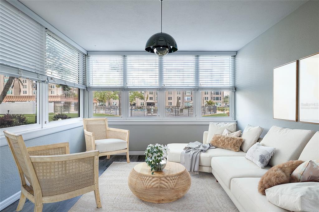 620 Edgewater Drive, Unit 103 Dunedin, FL 34698 - Photo 11 of 26 a living room with furniture and large windows