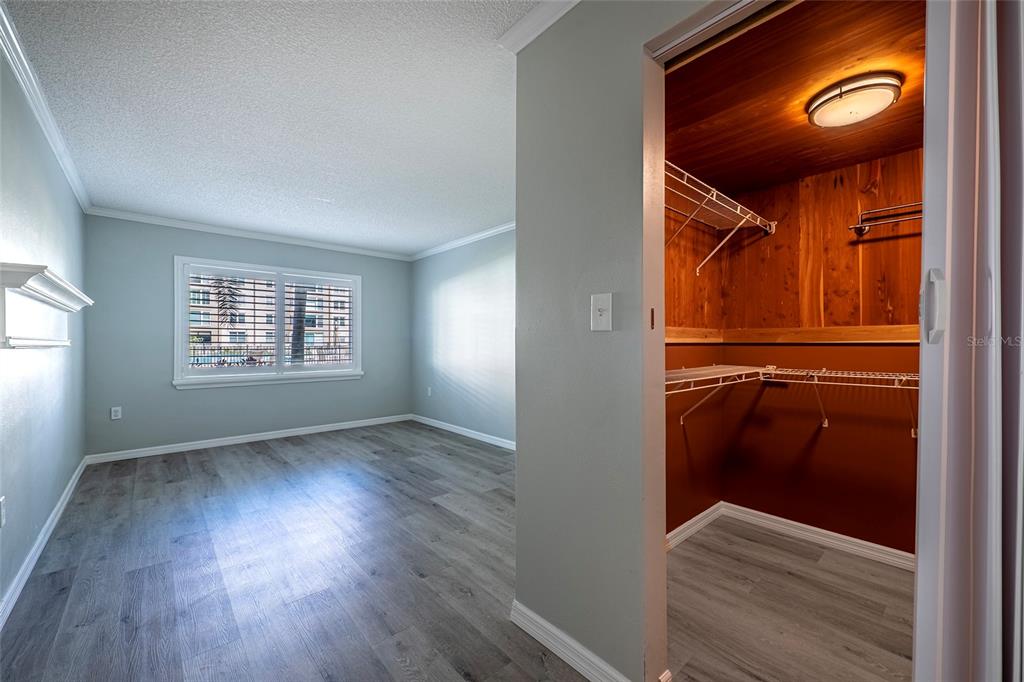620 Edgewater Drive, Unit 103 Dunedin, FL 34698 - Photo 15 of 26 an empty room with wooden floor and windows