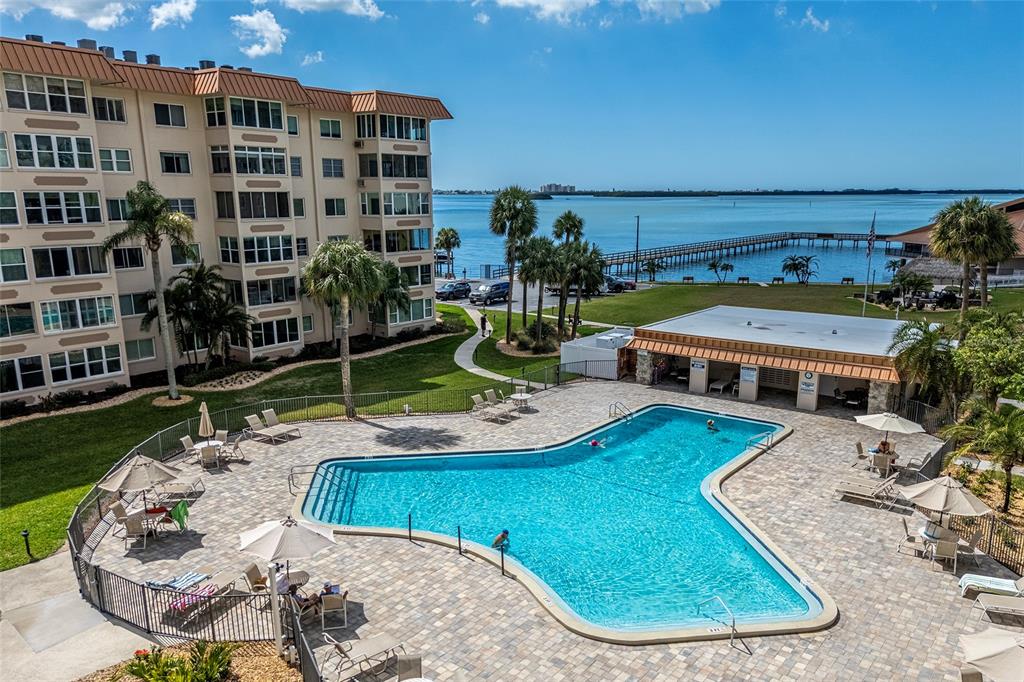 620 Edgewater Drive, Unit 103 Dunedin, FL 34698 - Photo 19 of 26 a view of a swimming pool with outdoor seating