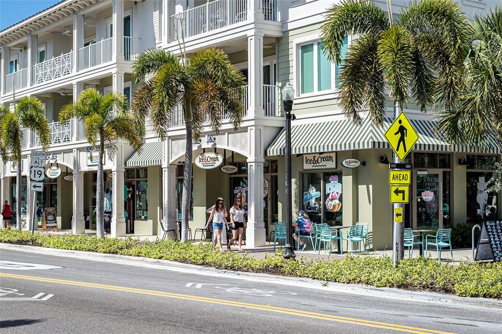 620 Edgewater Drive, Unit 103 Dunedin, FL 34698 - Photo 24 of 26 a view of a building and a people on a street