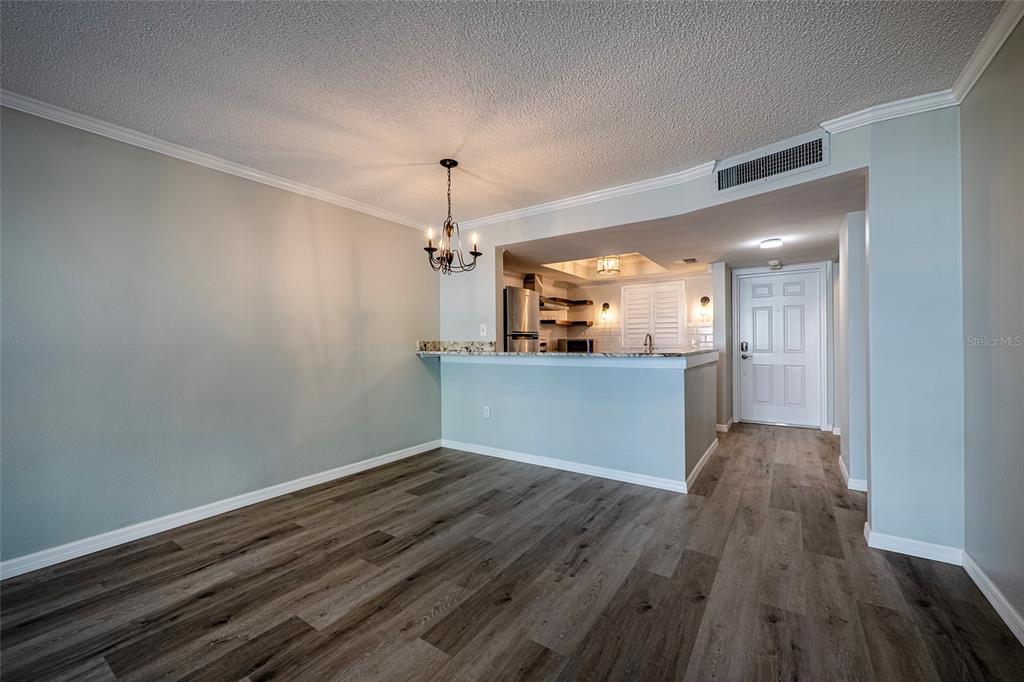 620 Edgewater Drive, Unit 103 Dunedin, FL 34698 - Photo 8 of 26 a view of a kitchen with a sink and wooden floor