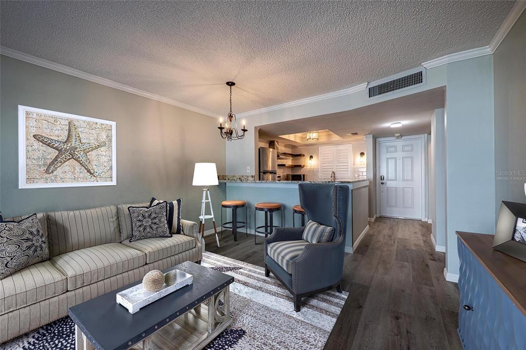 620 Edgewater Drive, Unit 103 Dunedin, FL 34698 - Photo 9 of 26 a living room with furniture and a wooden floor