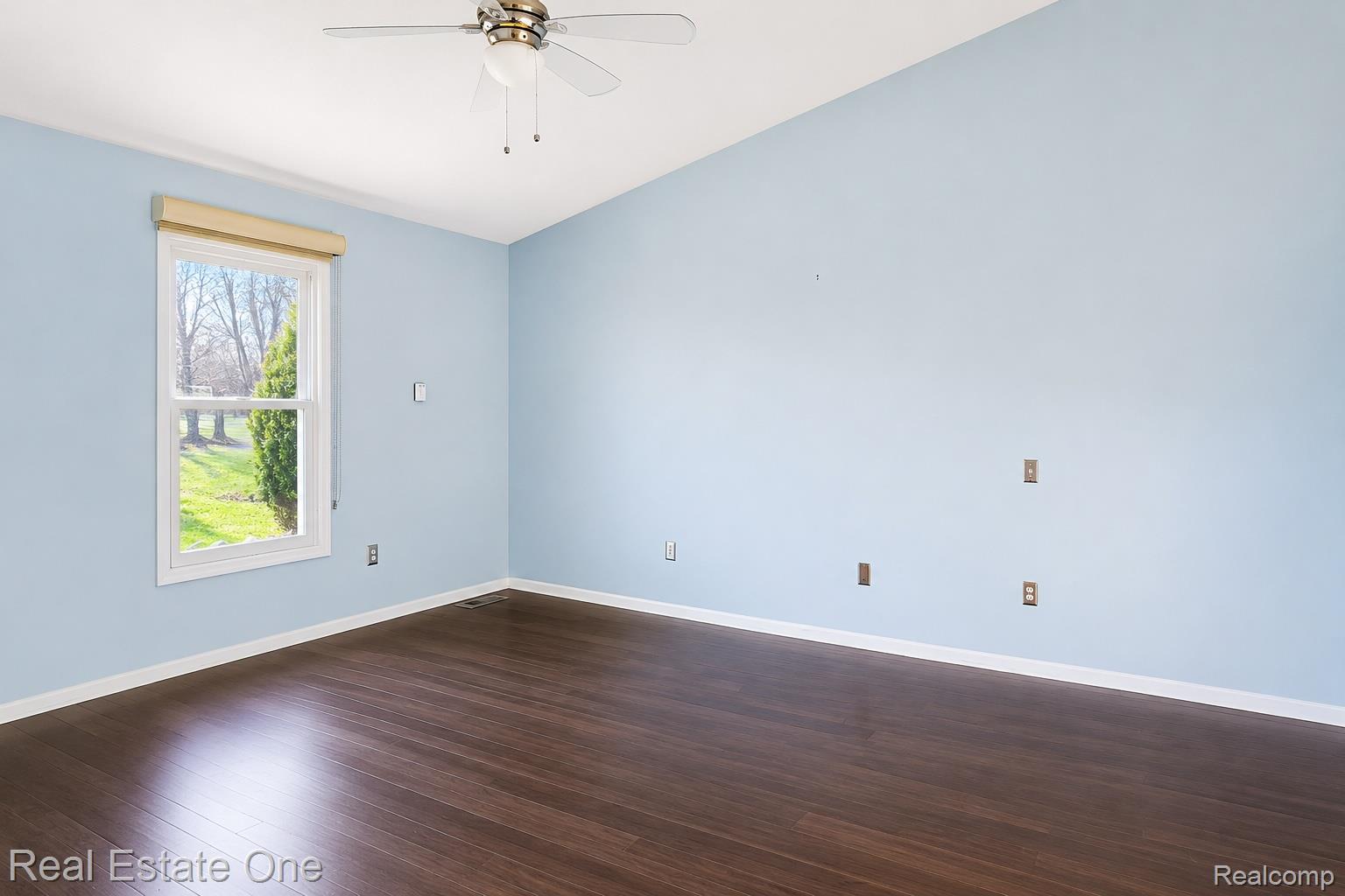 1141 Sandy Ridge Drive Rochester, MI 48306 - Photo 8 of 9 Spacious room featuring wood-finish flooring, a vaulted ceiling, and a ceiling fan with light fixture