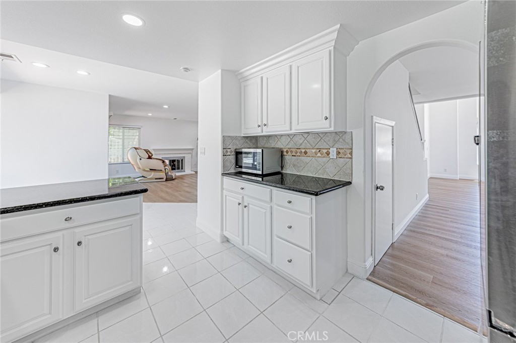 25533 Longfellow Place Stevenson Ranch, CA 91381 - Photo 15 of 47 a kitchen with white cabinets