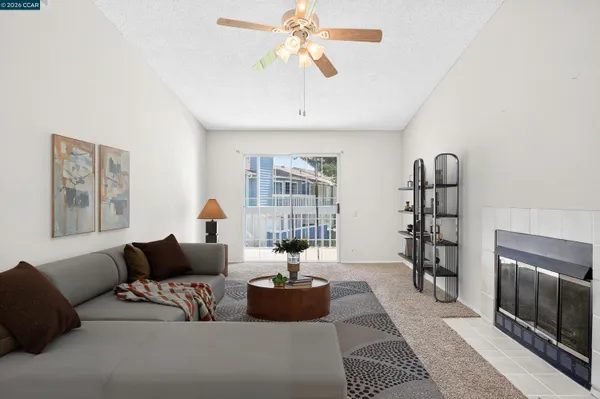 a kitchen with stainless steel appliances a stove a refrigerator cabinets and couches