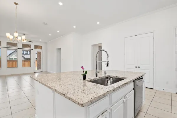 a kitchen with stainless steel appliances granite countertop a sink and white cabinets