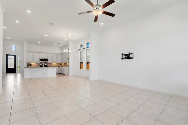 a view of kitchen with furniture and refrigerator