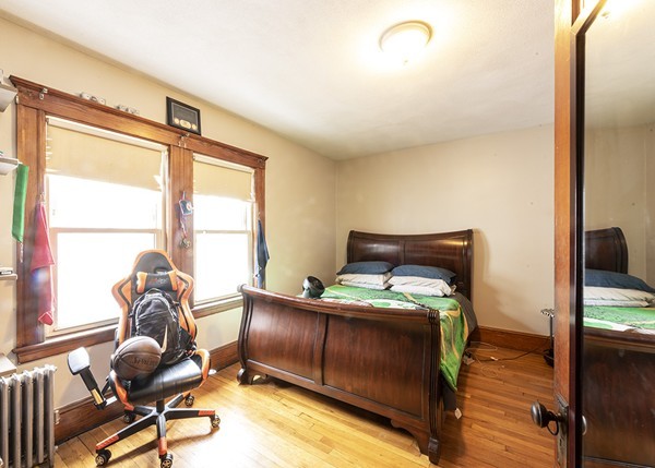 223 Ferry Street Everett, MA 02149 - Photo 11 of 24 a bedroom with a bed and a window