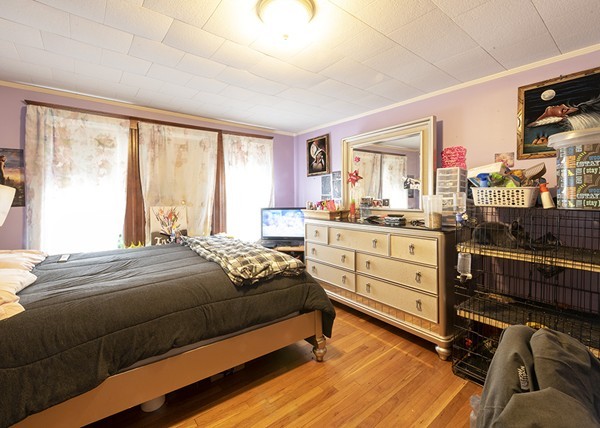 223 Ferry Street Everett, MA 02149 - Photo 14 of 24 a bedroom with a bed and large windows