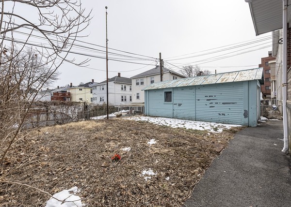 223 Ferry Street Everett, MA 02149 - Photo 19 of 24 a view of a large house with a snow on the road