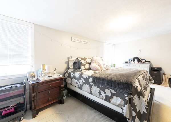 223 Ferry Street Everett, MA 02149 - Photo 2 of 24 a bed sitting in a bedroom next to a window