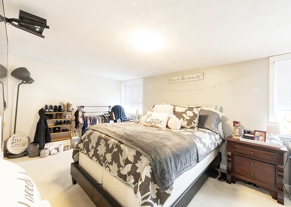 223 Ferry Street Everett, MA 02149 - Photo 3 of 24 a bedroom with a bed and a dresser