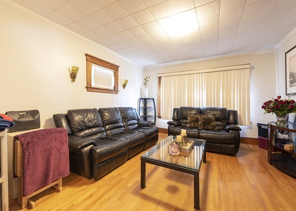223 Ferry Street Everett, MA 02149 - Photo 5 of 24 a living room with furniture and a wooden floor