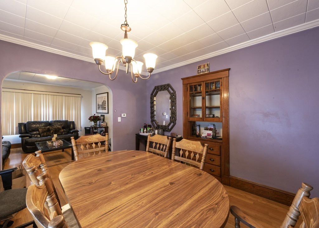 223 Ferry Street Everett, MA 02149 - Photo 7 of 24 a bed room with a bed mirror and a desk