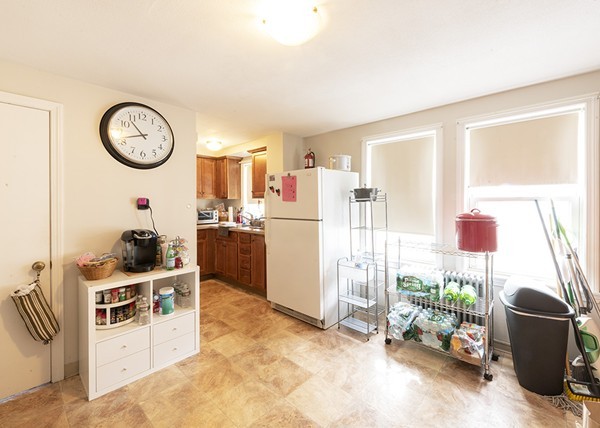 223 Ferry Street Everett, MA 02149 - Photo 9 of 24 a living room with furniture a clock and a window