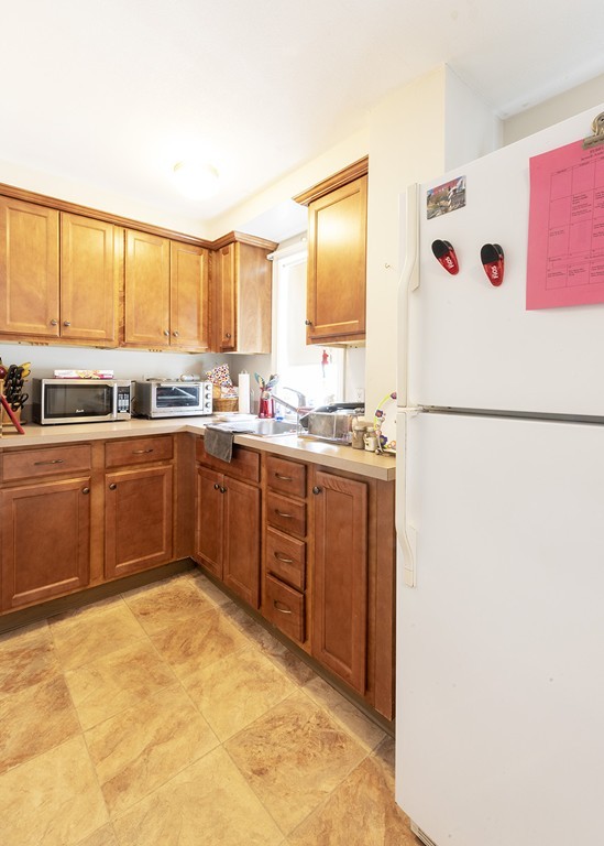 223 Ferry Street Everett, MA 02149 - Photo 10 of 24 a kitchen with a sink a window and appliances