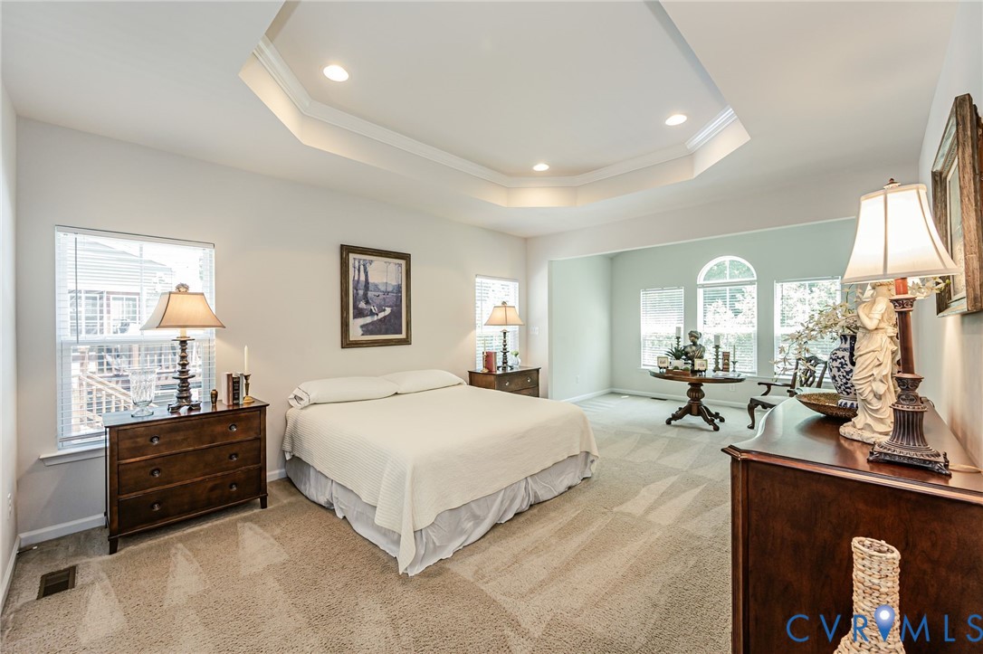 7435 Wicks Road Williamsburg, VA 23188 - Photo 40 of 82 Spacious Primary Suite featuring a tray ceiling wi