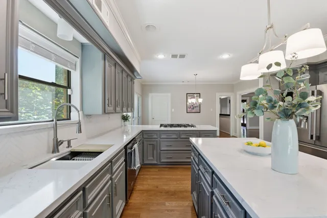 an empty room with wooden floor and ceiling fan