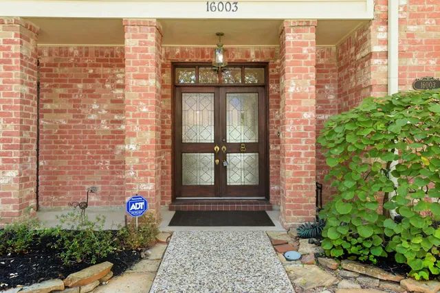 a large kitchen with granite countertop a large counter top space appliances and cabinets