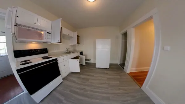a kitchen with a sink stove and refrigerator