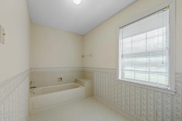 a white bath tub sitting next to a window
