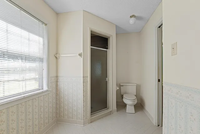 a bathroom with a toilet sink and a shower