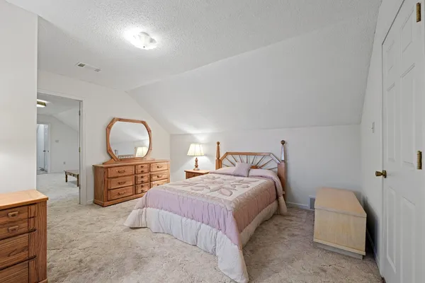 a bedroom with a bed and dresser