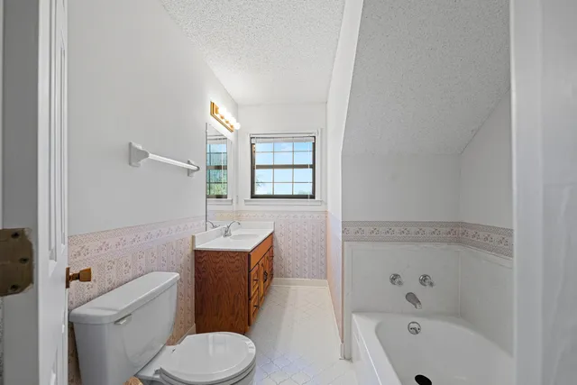 a bathroom with a toilet a sink and bathtub