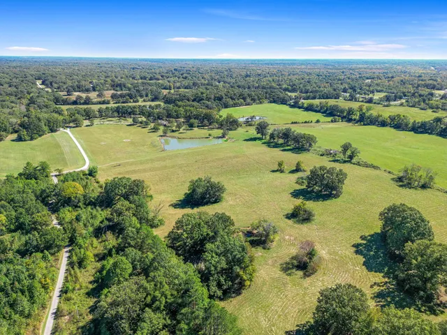 an aerial view of a houses with a lake view