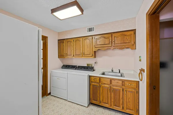 a kitchen with stainless steel appliances granite countertop a sink and cabinets