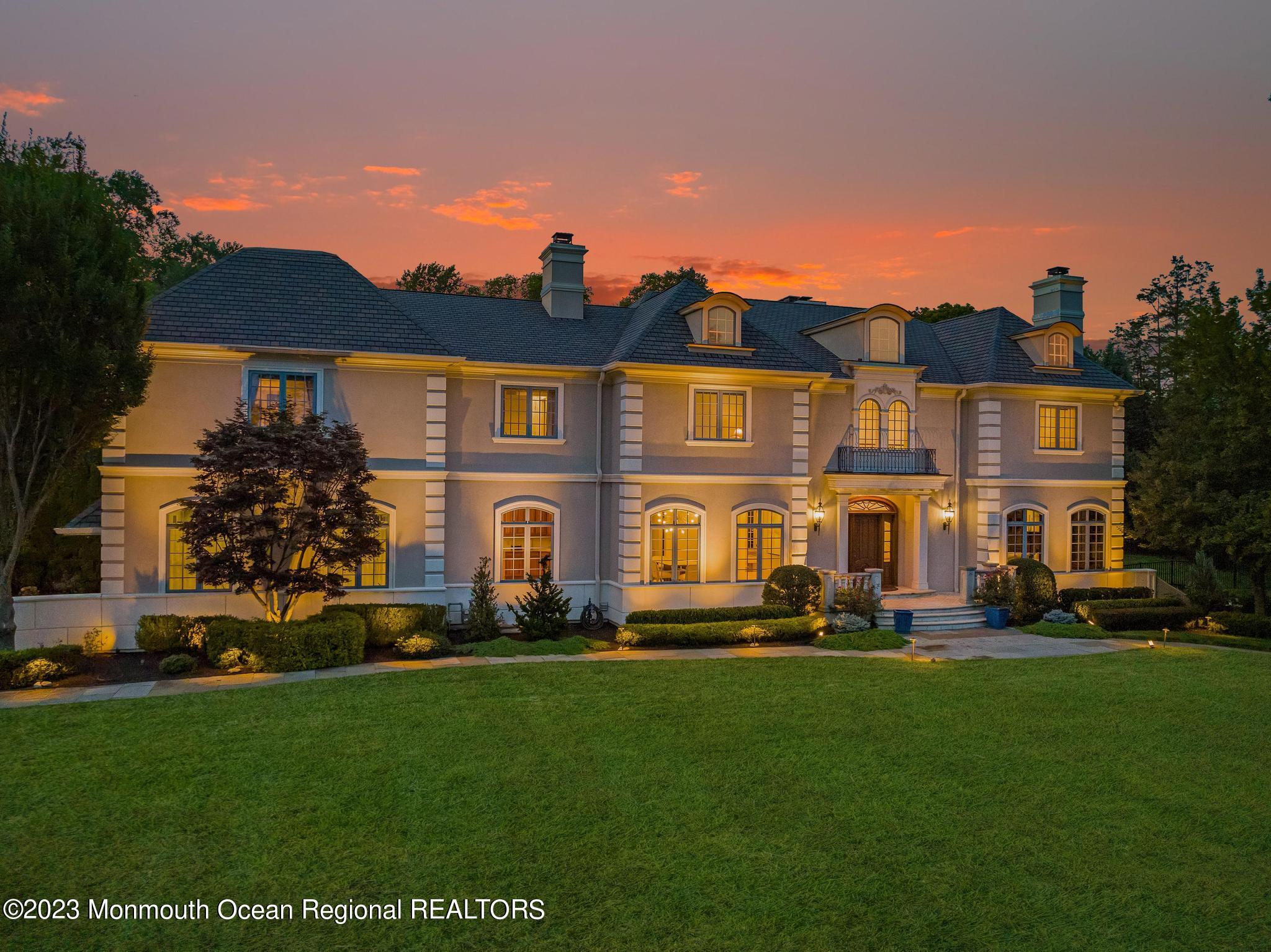 122 Rumson Road Rumson, NJ 07760 - Photo 2 of 100 a front view of a house with a garden and plants