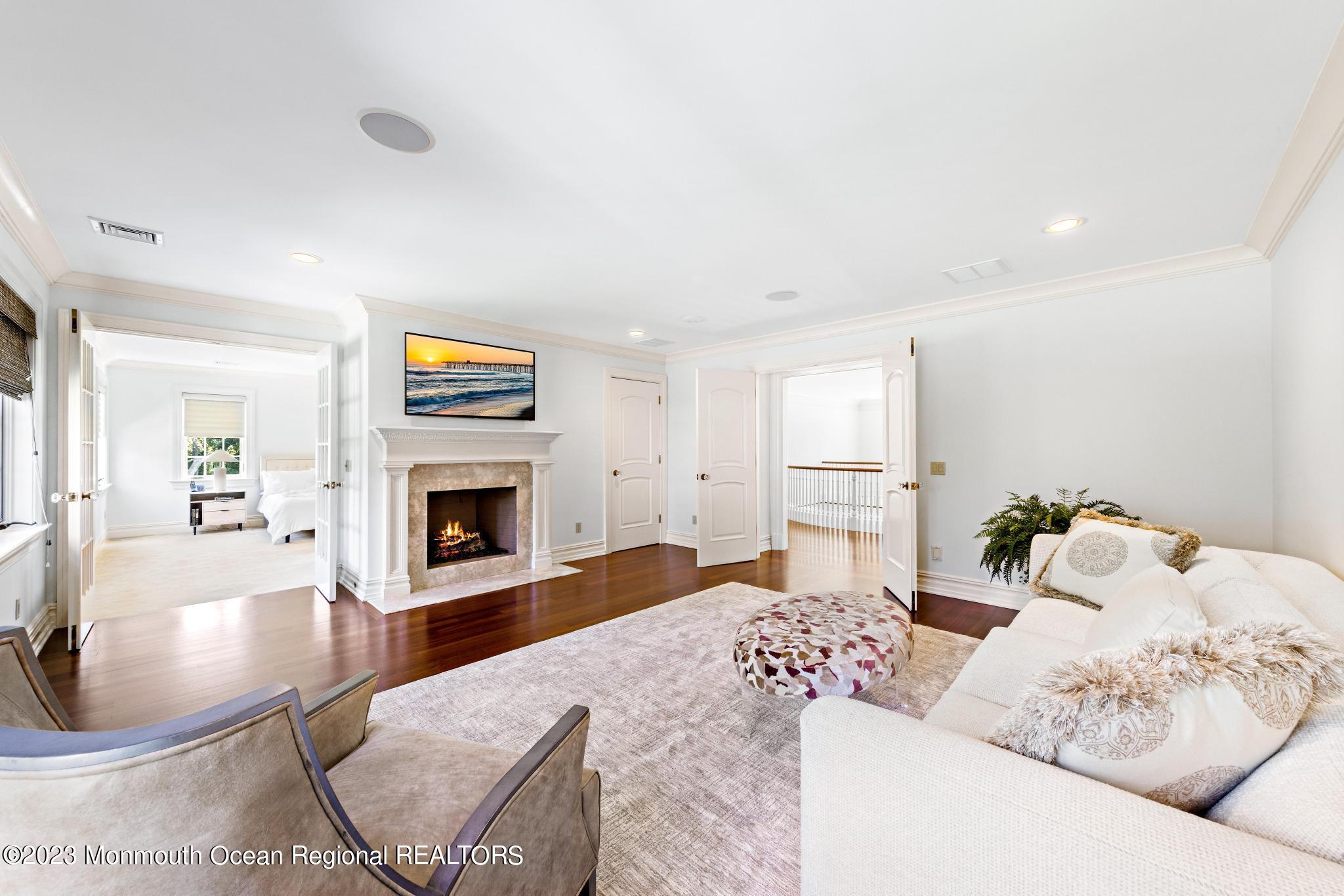 122 Rumson Road Rumson, NJ 07760 - Photo 38 of 100 a living room with furniture a fireplace and a flat screen tv
