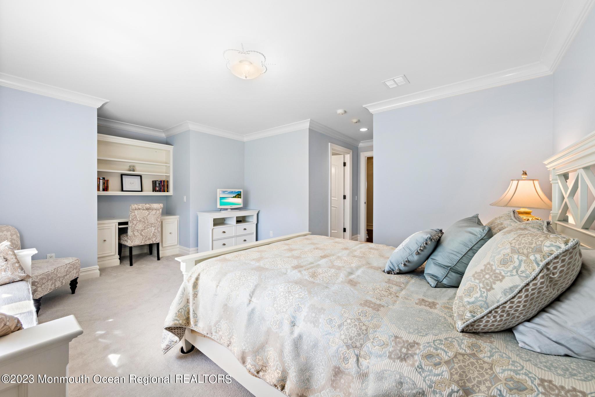 122 Rumson Road Rumson, NJ 07760 - Photo 49 of 100 a bedroom with a large bed and a wooden floor