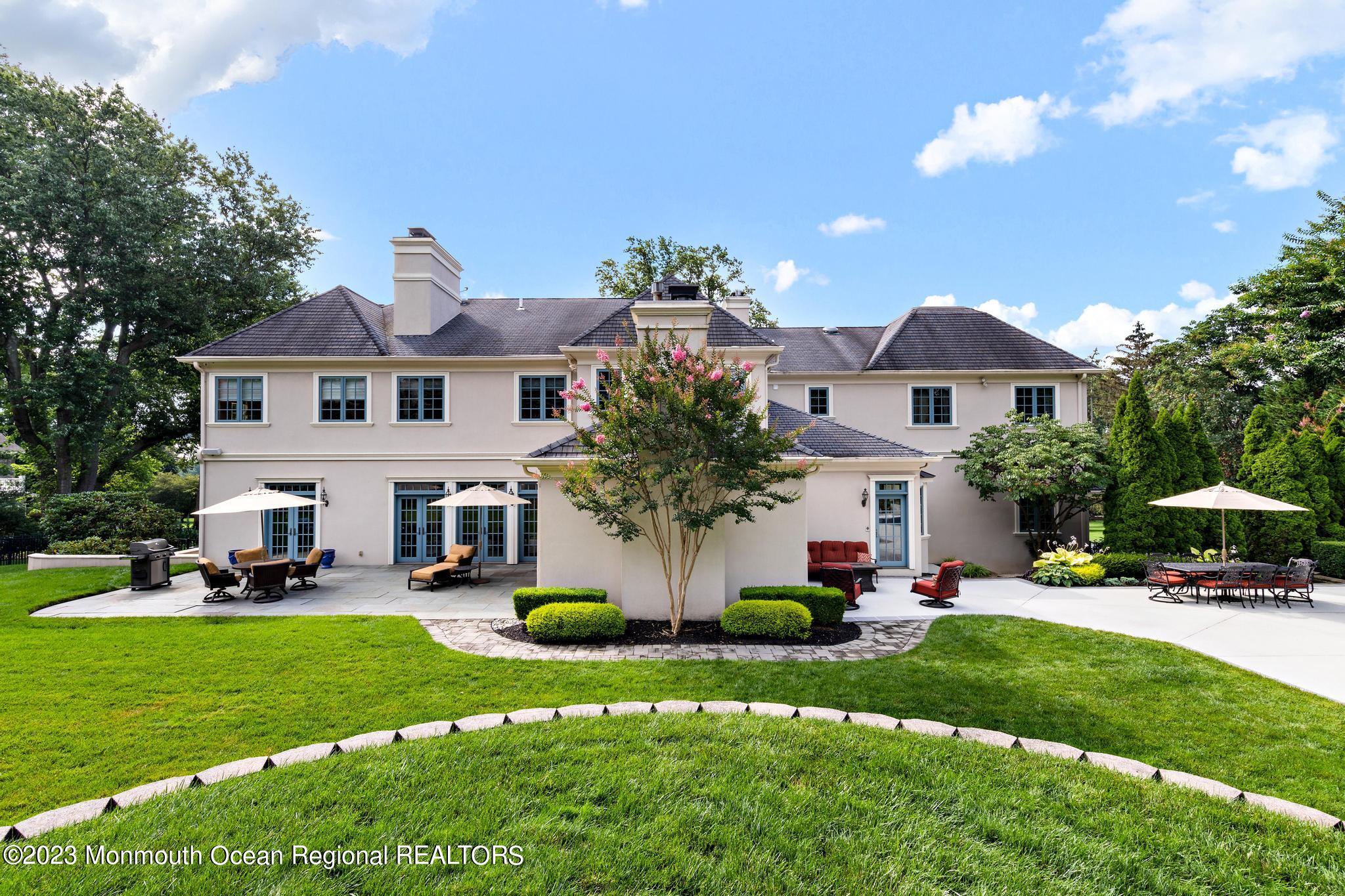 122 Rumson Road Rumson, NJ 07760 - Photo 91 of 100 a front view of a house with a garden and plants