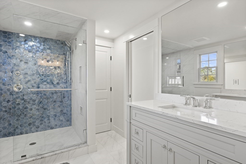 29 Mercier Way Edgartown, MA 02539 - Photo 15 of 29 a bathroom with a shower sink and mirror