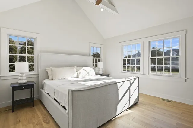 a spacious bedroom with a bed and a window