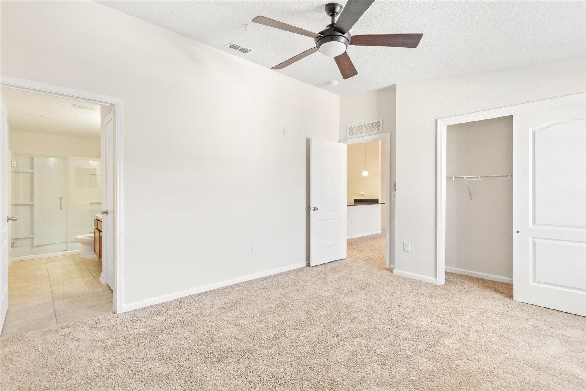 1511 Golden Lake Loop St. Augustine, FL 32084 - Photo 11 of 30 an empty room and chandelier fan in hallway