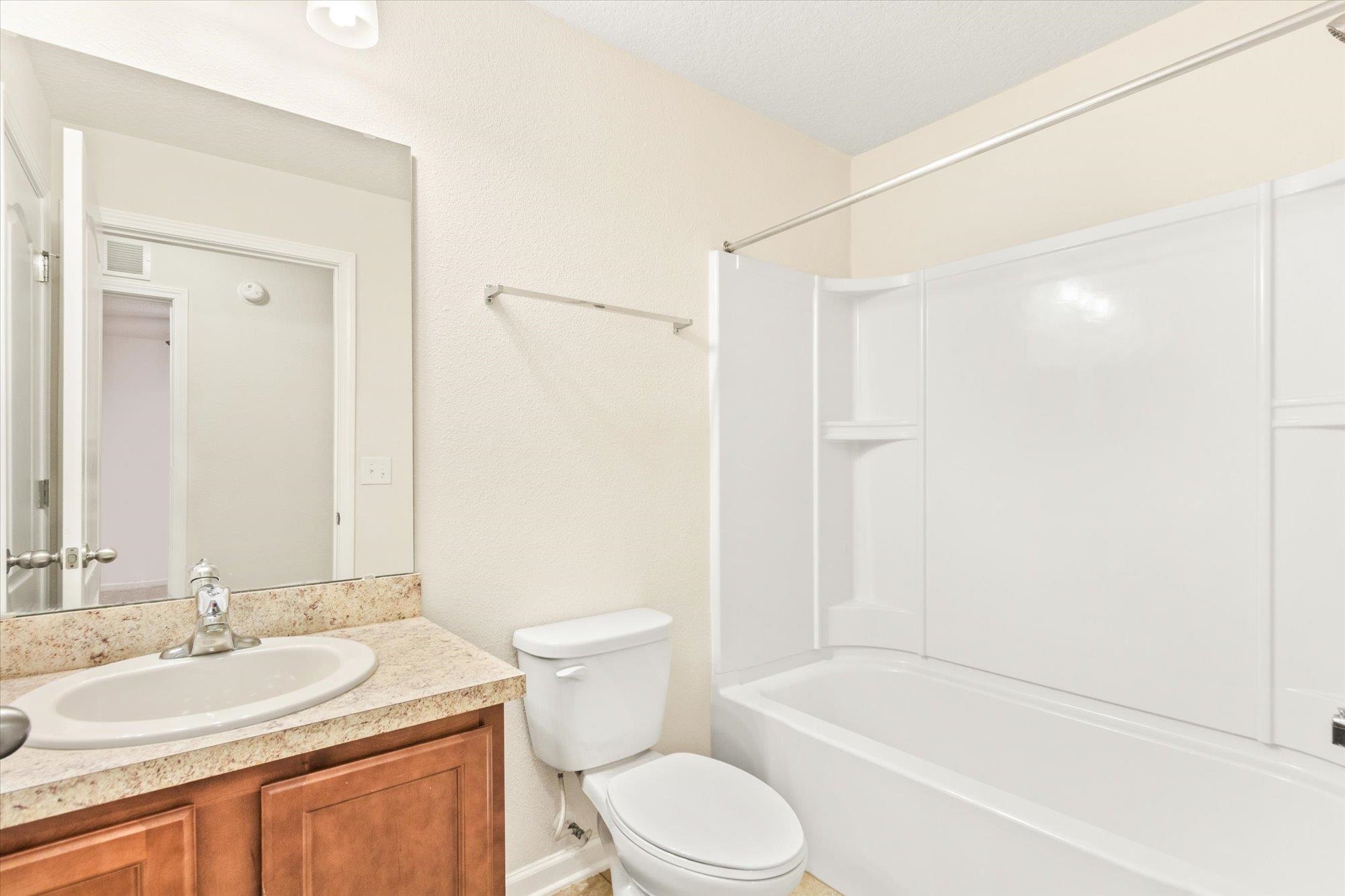 1511 Golden Lake Loop St. Augustine, FL 32084 - Photo 17 of 30 a bathroom with a granite countertop sink toilet and shower