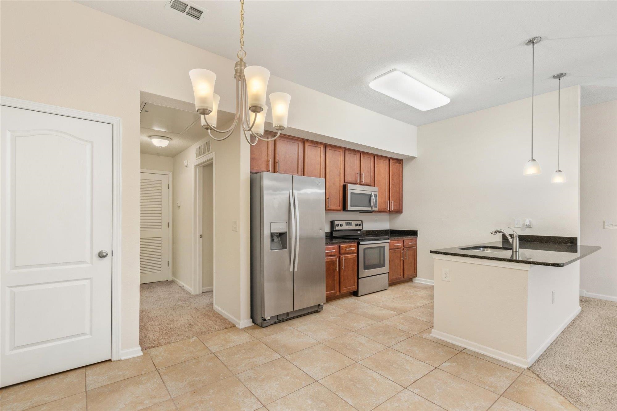 1511 Golden Lake Loop St. Augustine, FL 32084 - Photo 7 of 30 a kitchen with stainless steel appliances granite countertop a refrigerator and a sink
