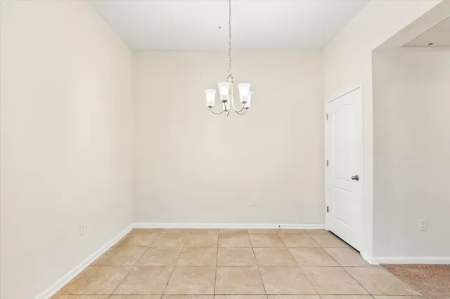 an empty room with window and ceiling fan