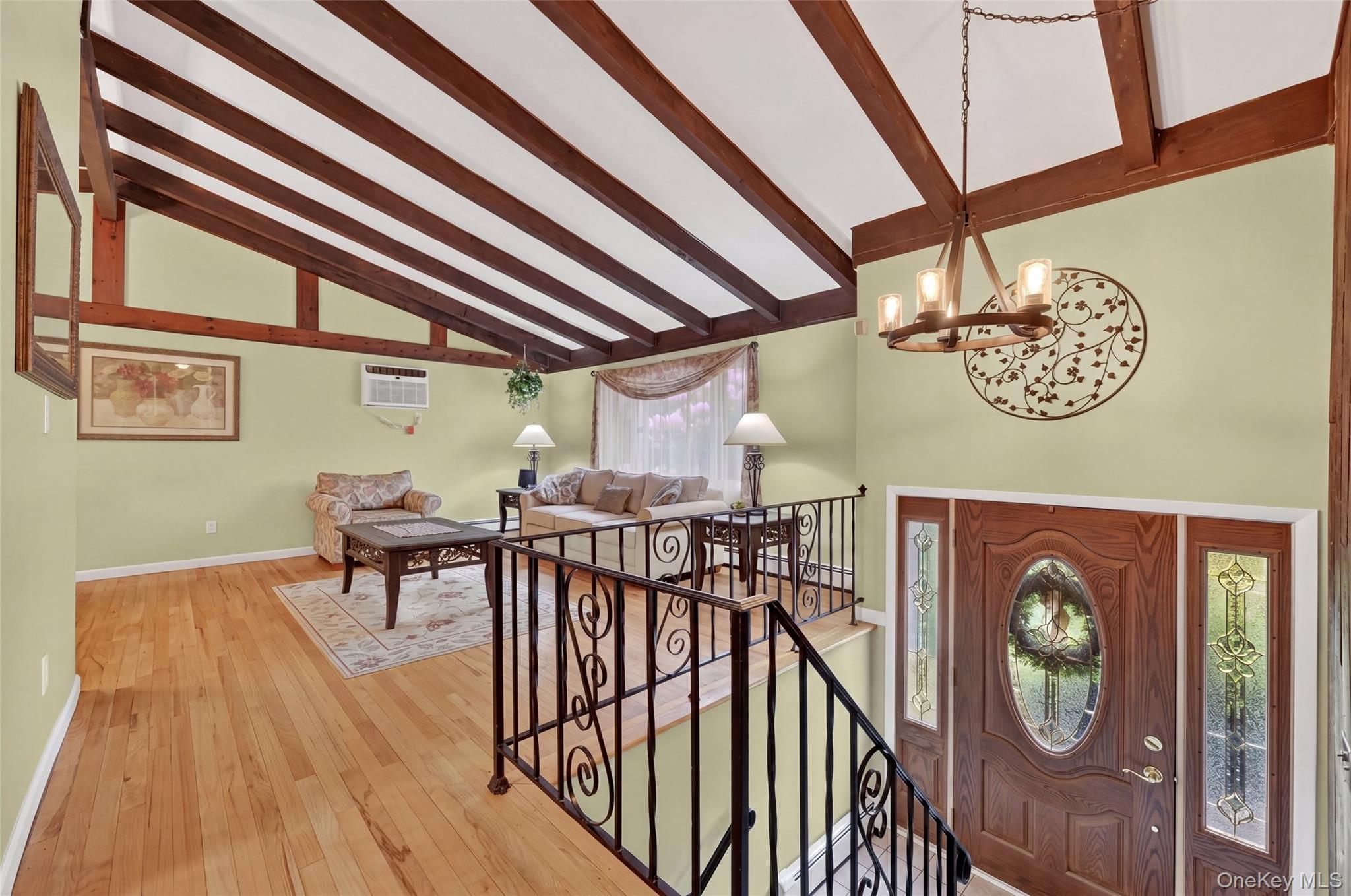 1 Rockledge Road Poughkeepsie, NY 12601 - Photo 3 of 36 Living room with Vaulted ceiling with exposed wood beams, hardwood flooring, tiled entry foyer with newer front door