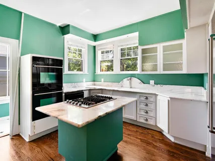 a kitchen with sink cabinets and wooden floor