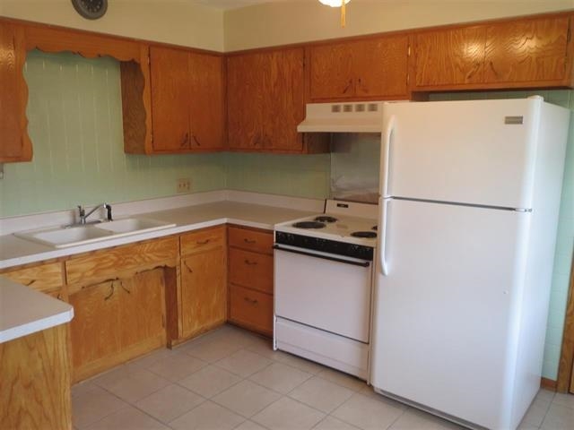 6103 Park Ridge Road Loves Park, IL 61111 - Photo 15 of 22 a kitchen with stainless steel appliances a refrigerator sink and cabinets